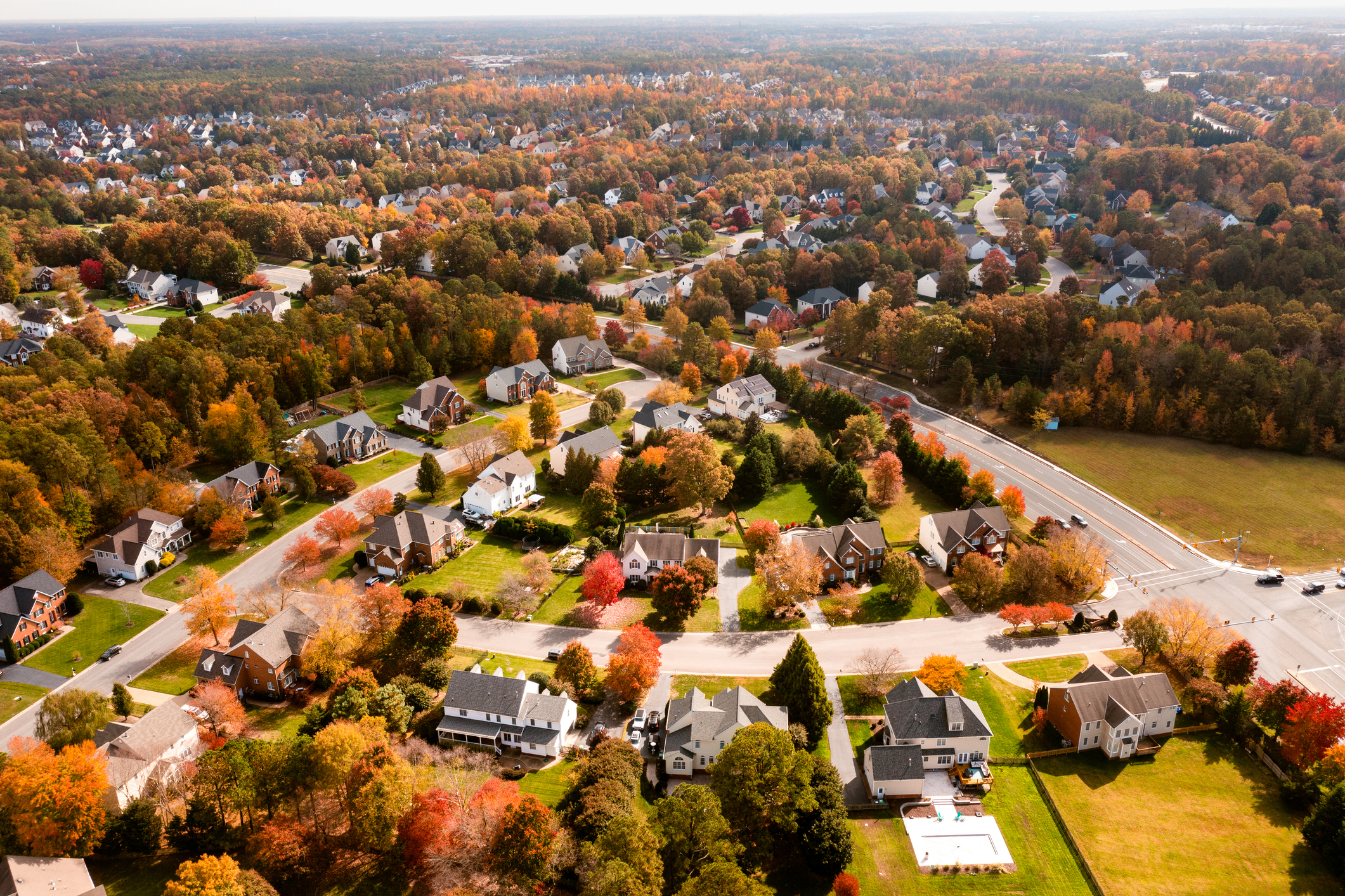 Aerial view of a suburban neighborhood with fall trees.